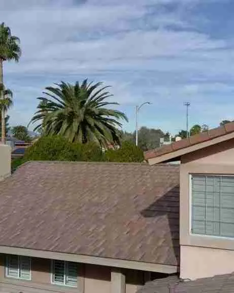 Professional roofer working on a residential roof - Roofing companies wellington